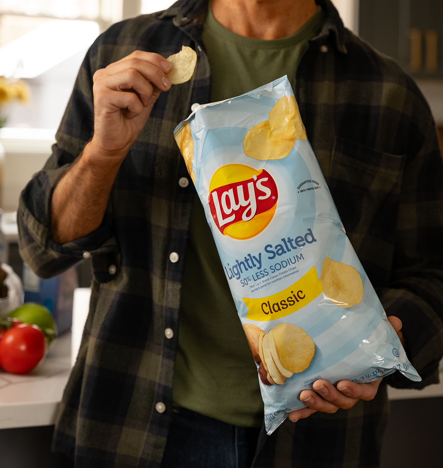 Man eating Lay's Lightly Salted chips