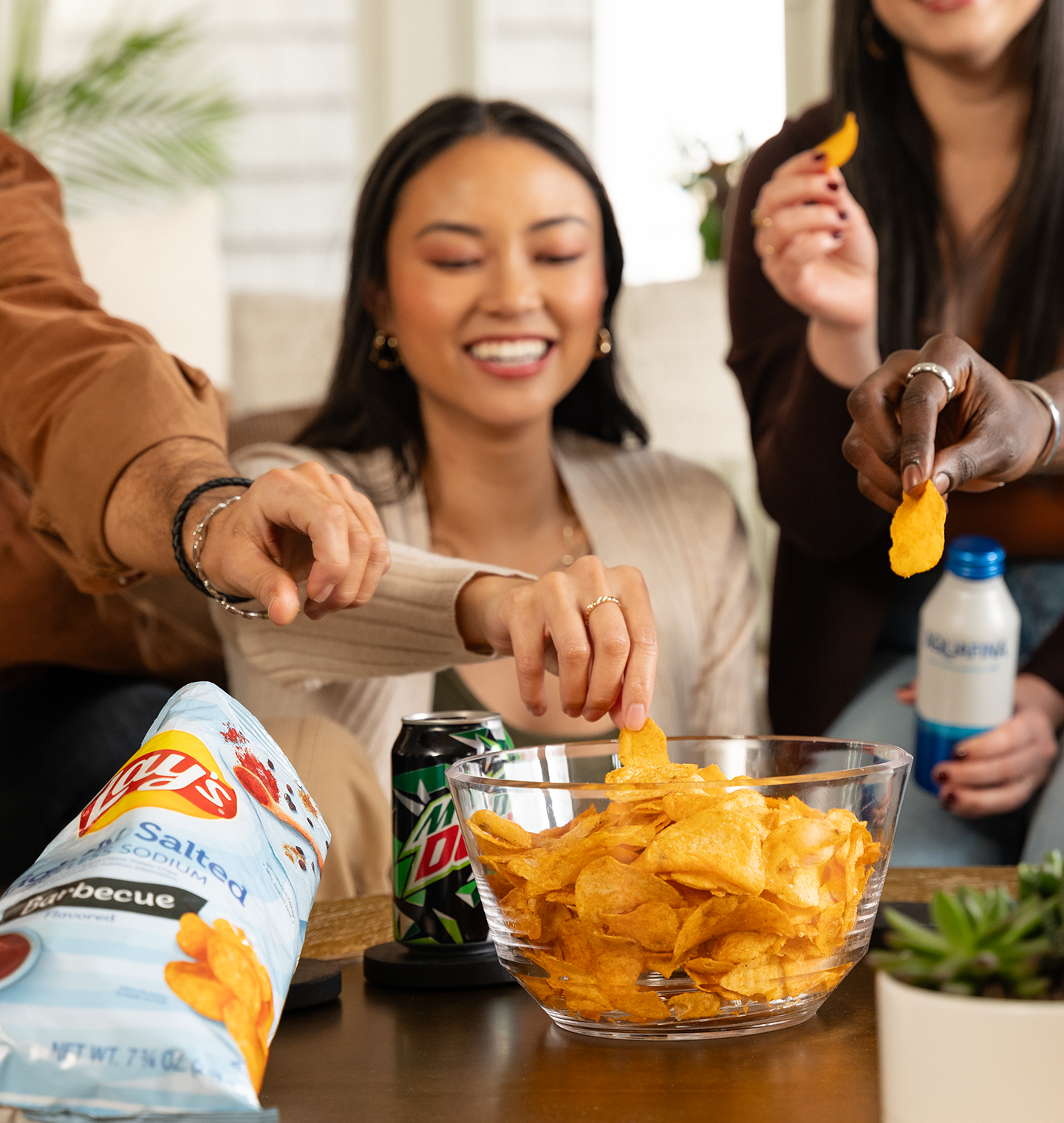 Friends eating Lay's Lightly Salted Barbeque chips