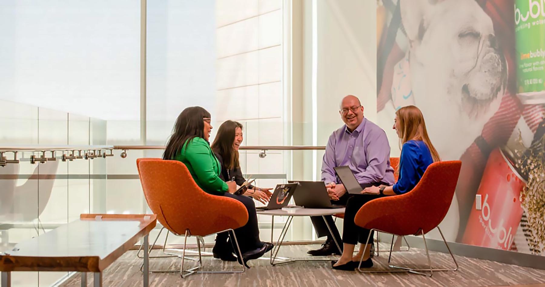 Colleagues collaborating in a meeting space in the office