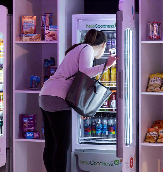 Woman picking a snack out of a Hello Goodness vending machine