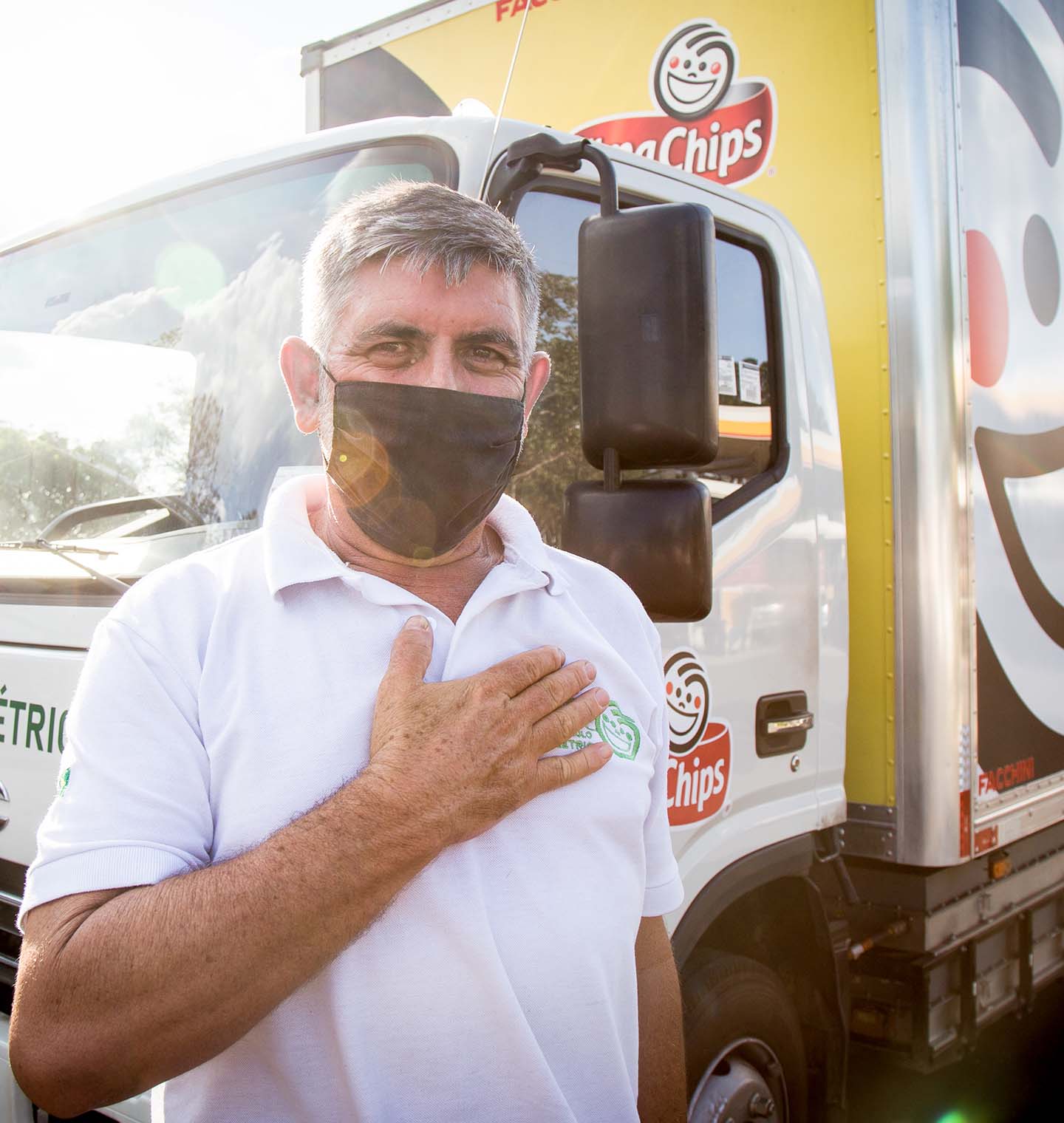 Driver standing next to an electric delivery truck