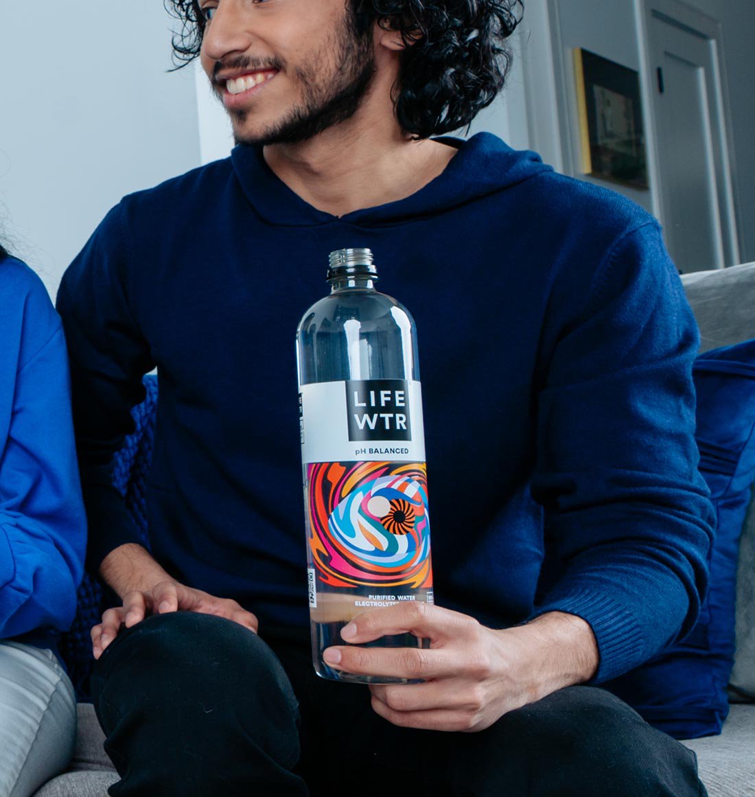 Man holding bottle of LIFE WATER