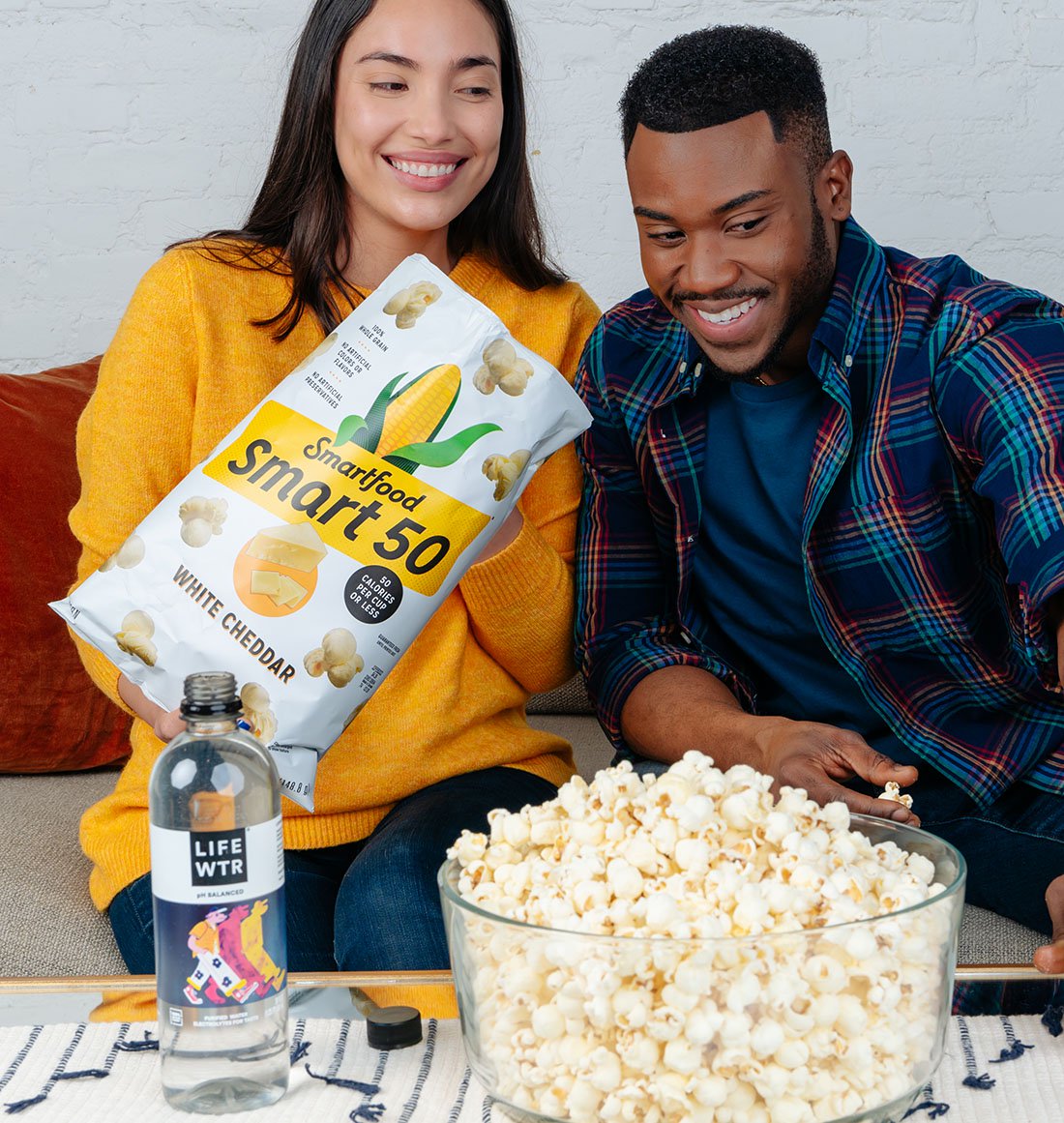 A couple shares popcorn during movie night