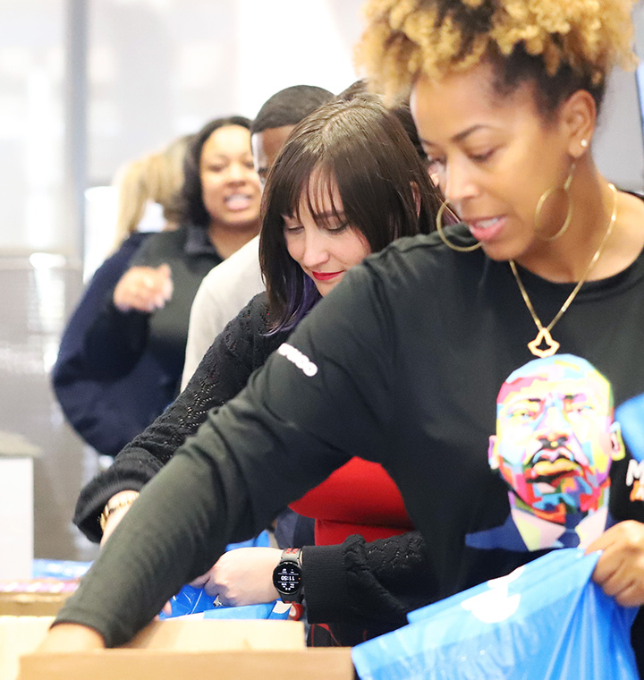 Volunteers putting meal kits