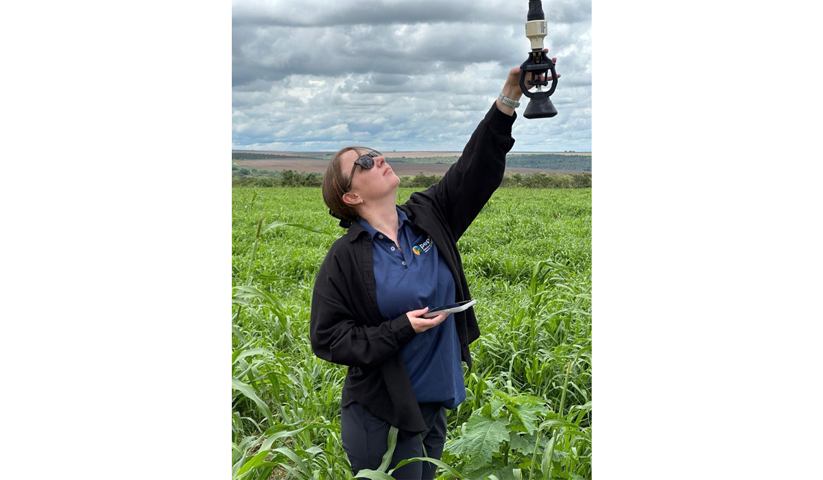 Miranda Allitt inspecting a water sprinkler