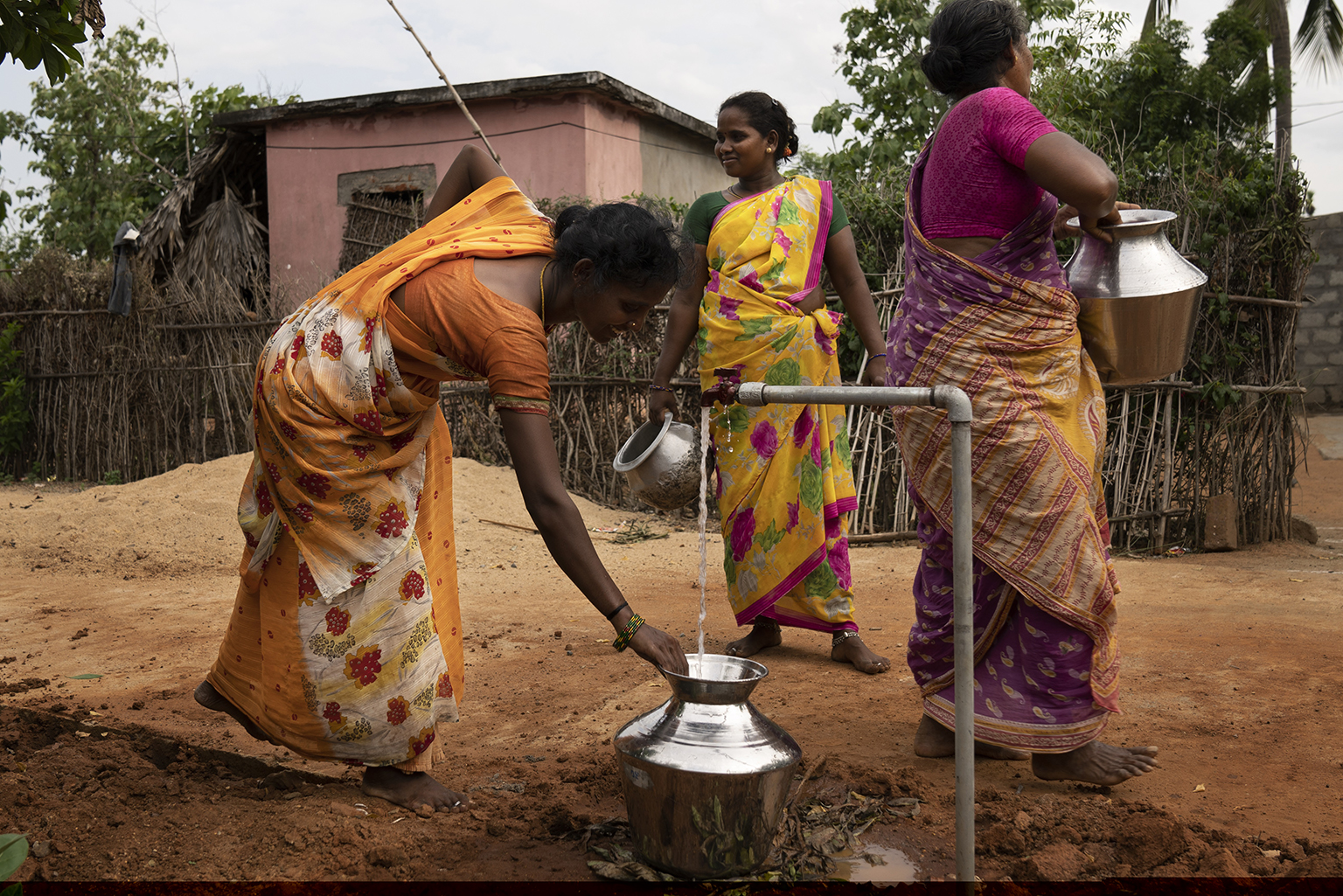 Women collect water from a new tap stand in Ananthapuram Chittoor District in the state of Andhra Pradesh