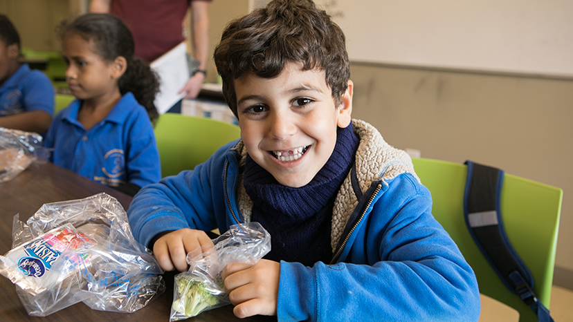 A boy enjoys lunch provided by Food For Good.