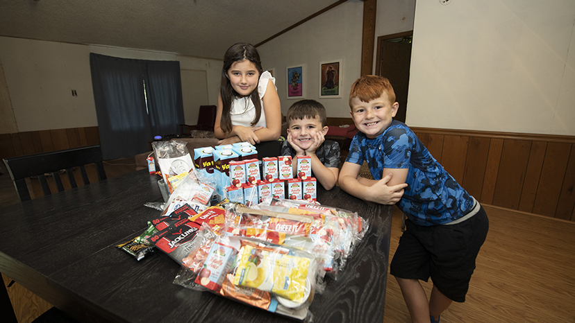 Children with a Food For Good shipment from earlier this year.