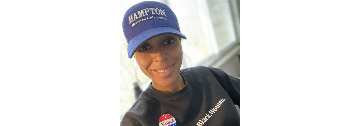 Nicole Jones wears a hat from her alma mater on Election Day.
