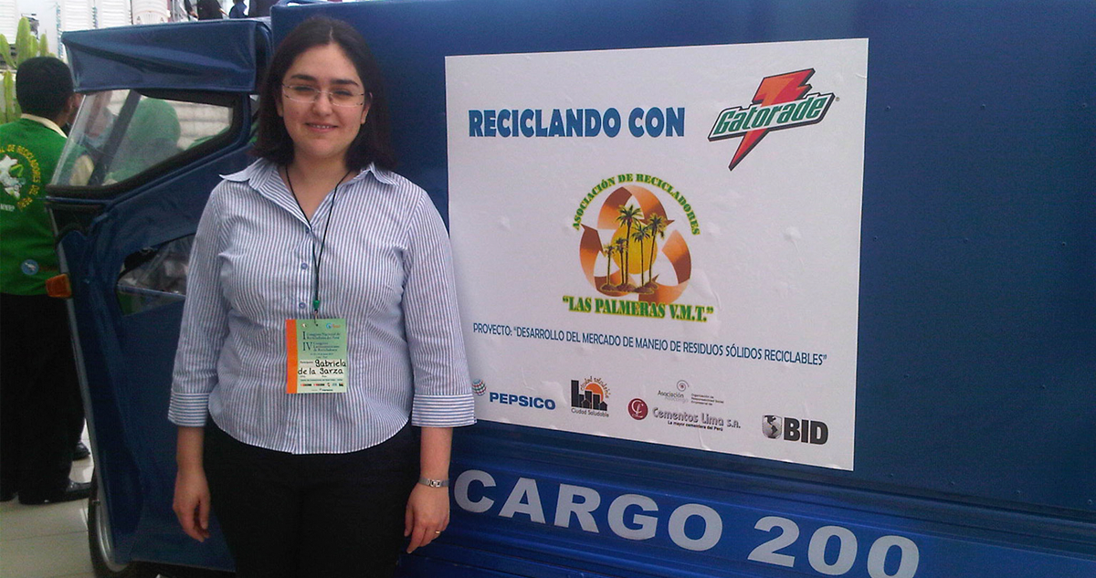 Gaby in front of a recycling transport vehicle PepsiCo provides grassroots recyclers in Peru.