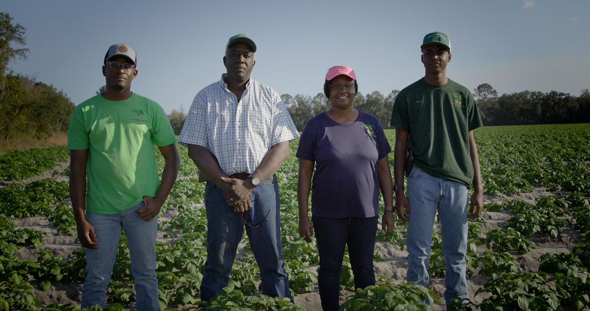 Singleton family standing on their potato farm