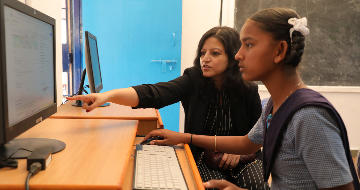 Srijita and student looking at computer