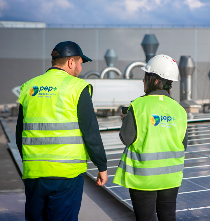 Two PepsiCo employees with pep vests