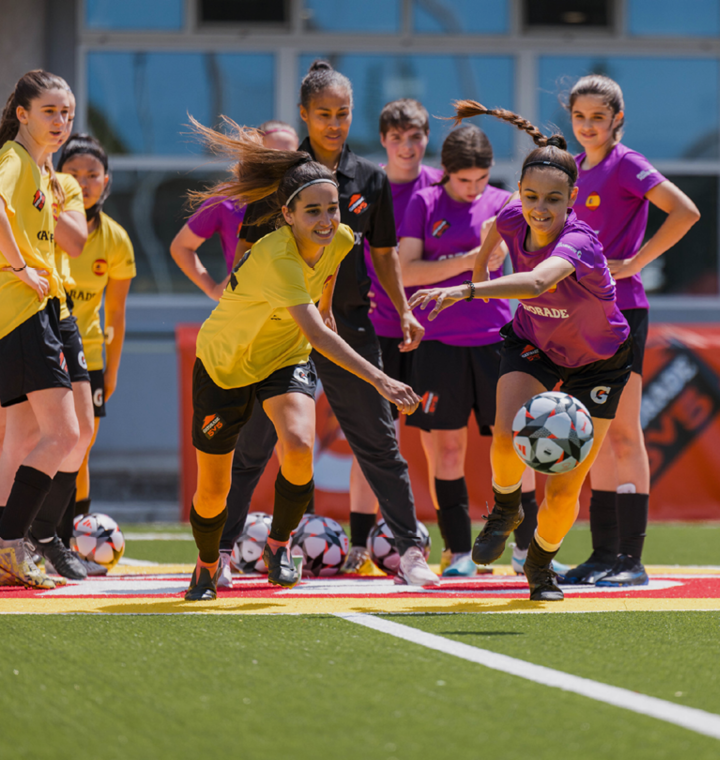 Image of two girls' soccer teams playing a game
