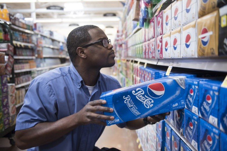 Frontline worker stocking the shelves at a grocery store